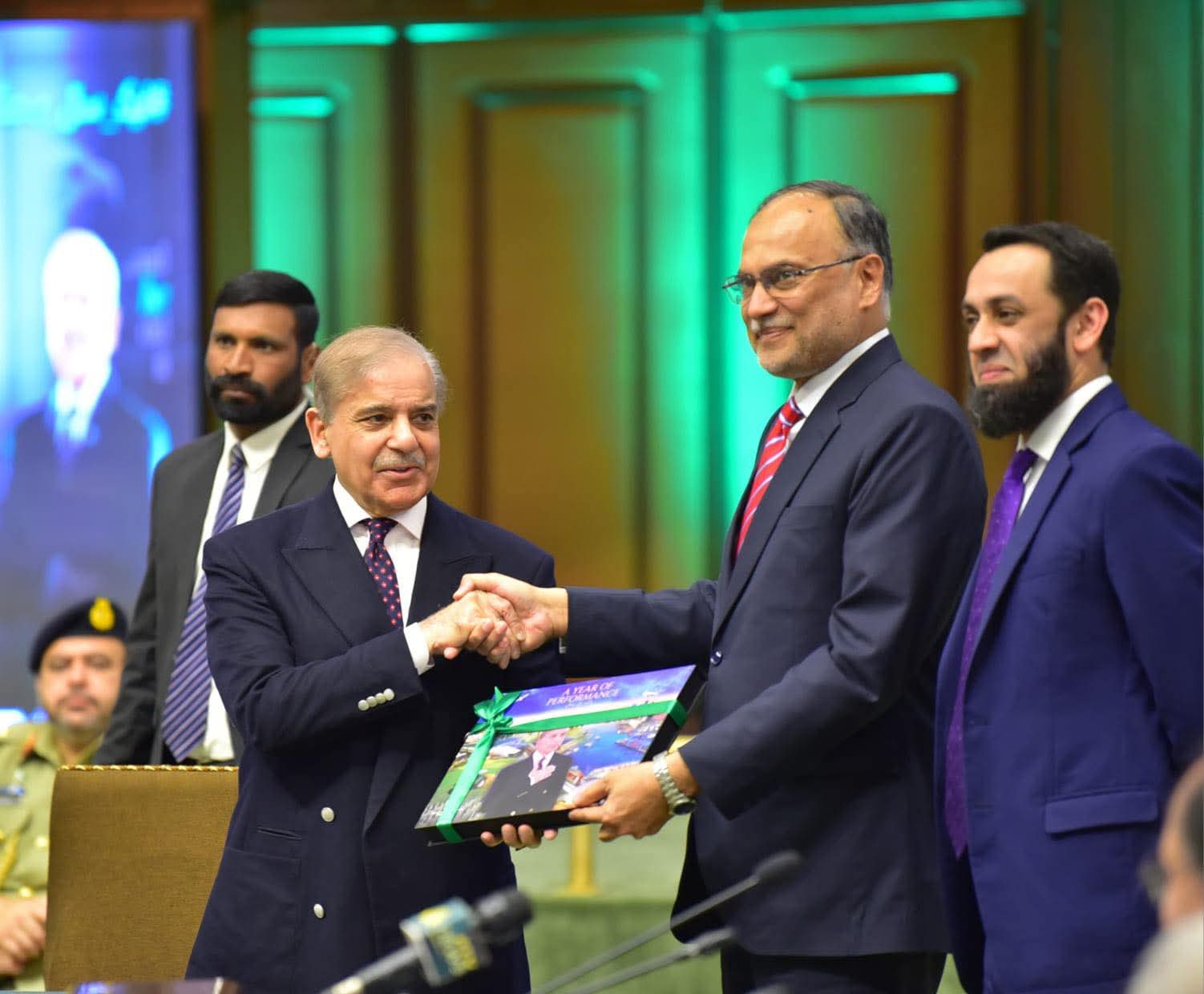 Islamabad: Prime Minister Muhammad Shehbaz Sharif being presented a book on one-year performance of the government by Minister for Planning, Development & Special Initiatives Ahsan Iqbal and Minister for Information & Broadcasting Ataullah Tarar during the Special Meeting of the Cabinet at Jinnah Convention Center Islamabad earlier today.